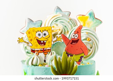 Kyiv, Ukraine - May 15, 2021: Birthday cake for a fan of SpongeBob SquarePants on white background. Nautical turquoise cake with characters of animated television series