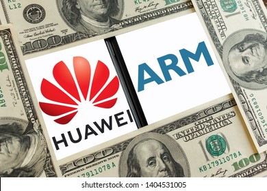 Kyiv, Ukraine – May 21, 2019: Logos of Huawei Technologies and ARM is a chip designer on the screens of the smartphones among us dollar bills. ARM's designs form the basis of mobile device processors 