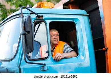 Kyiv, Ukraine, May 26, 2019. Garbage Truck Driver Smokes In The Truck Cab