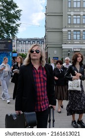 Kyiv, Ukraine - May 28 2022: Man Musician On Street With Guitar Case