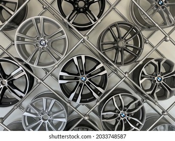 Kyiv, Ukraine. May 9, 2021. BMW Car Rims Hang On A Wall At A Car Dealership. Alloy Wheels In Service Center. Booth, Rack With Lots Of Different Automobile Wheels, A Legendary Automaker's Brand Logo.