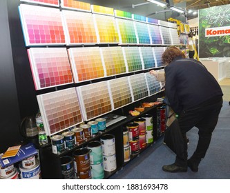 KYIV, UKRAINE - November, 26, 2020: A Customer Is Choosing The Right Interior Paint Color Using The Paint Color Palette In The Store.