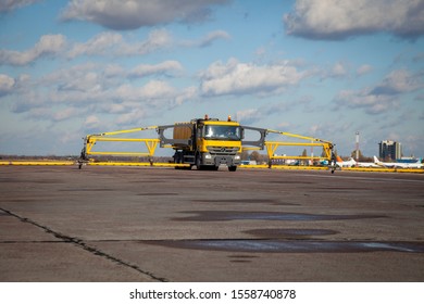 Kyiv, Ukraine - November 5, 2019: De Icing Machine. Special Equipment - Cleaning The Airport, Roads And Streets. A Large Yellow Mercedes Car With An Anti-icer Sprinkler Is Expensive.