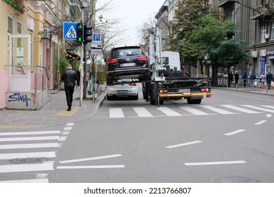 Kyiv, Ukraine - October 13 2022: Car Is Towed Away From Downtown Street By Tow Truck For Parking Violation