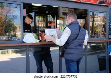 Kyiv, Ukraine - October 15 2022: Man Buying Snacks And Drink At Street Kiosk