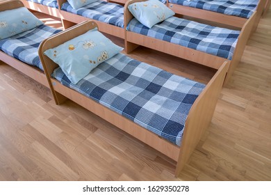 Kyiv, Ukraine - October 2, 2019: Many Small Beds With Fresh Linen In Daycare Preschool Empty Bedroom Interior For Comfortable Afternoon Nap Of The Kids.