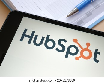 KYIV, UKRAINE - October 21, 2021. Tablet with HubSpot company logo and notebook.
