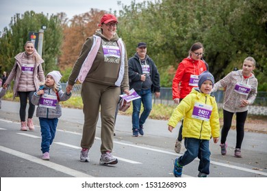 Kyiv, Ukraine - October 5, 2019. Running People - The Family Run. Runners Dad, Mom, Baby, Kids. Run Of The Competition As Part Of The Marathon.