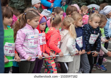 Kyiv, Ukraine - October 5, 2019: Little Children Stand On The Start Line. Children's Street Running Competition. Jogging Children. Kids Run. Children Race. Mass Start, Training Before The Marathon.