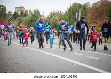 Kyiv, Ukraine - October 5, 2019: A Family Race As Part Of The Marathon. Running People, Parents And Children Participate In A Street Sporting Event.