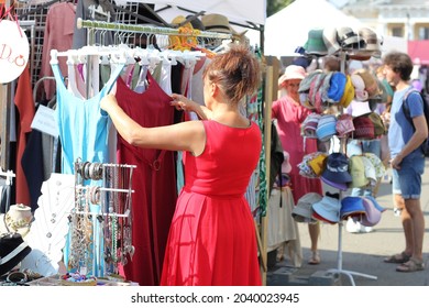 Kyiv, Ukraine - September 11 2021: woman looking at dresses at the street fair