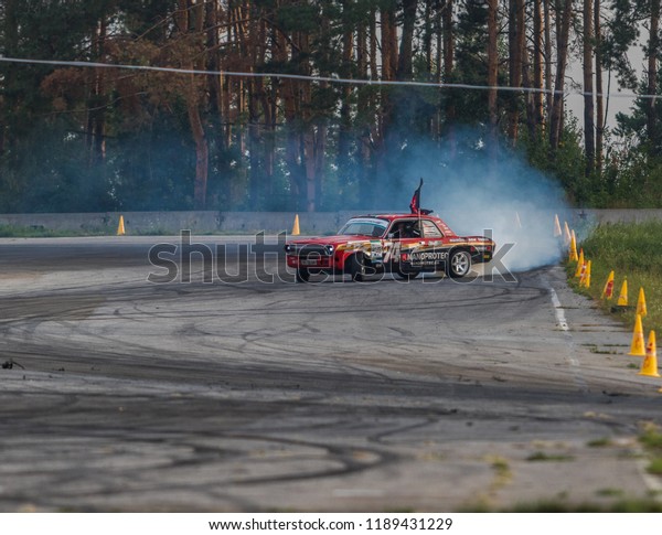Kyiv, Ukraine - September 15, 2018: Car\
drifting, Blurred of image diffusion race drift car with lots of\
smoke from burning tires on speed\
track