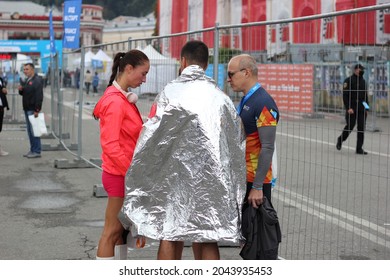 Kyiv, Ukraine - September 19 2021: Athlete Standing On Street Covered With Space Blanket After Running Marathon