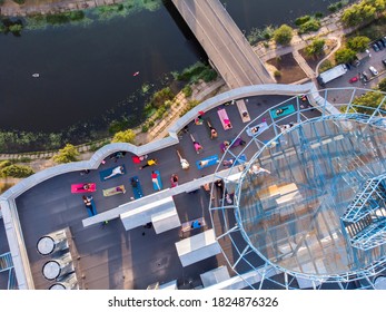 KYIV, UKRAINE - SEPTEMBER 2020: Group Of Adults Peoples Doing Yoga Outdoors On The Roof Of The High Building. Outdoor Group Yoga Classes Back View. Many People Do Yoga Exercises. Meditation And