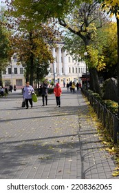 Kyiv, Ukraine - September 29 2022: People Walking On Alleyway With Fallen Autumn Leaves