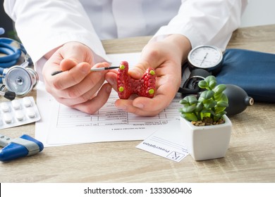 KYIV, UKRAINE-MARCH 8, 2018: At doctors appointment physician shows to patient shape of thyroid with parathyroid glands with focus on hand with organ. Scene explaining patient causes and localization  - Shutterstock ID 1333060406