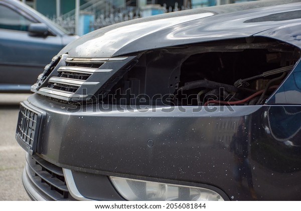 KYIV, UKRAINE-September 25, 2021: Broken\
black car after an accident with no headlights, vehicle\
registration plate and car marker logo. Car accident\
concept