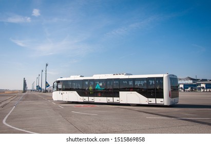 KYIV, UKRINE-MAY 7, 2019: white airport shuttle bus carries passengers to the plane at the Boryspil International Airport. Aviation service. Space for text.