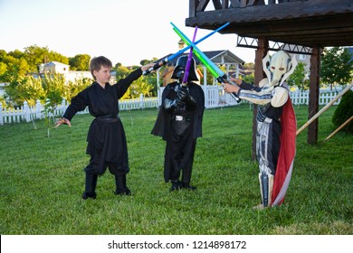 Kyiv/Ukraine - August 15, 2018: Cosplayers Kids Dressed As Characters From Star Wars Movie  With Swords And Play. Halloween Costumes, Cosplay Concept