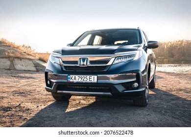 Kyiv,Ukraine - October 2021: Honda Pilot Touring 2019 in a gary color near the river on a sunny day. Photoshoot