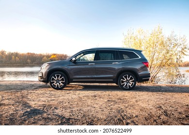 Kyiv,Ukraine - October 2021: Honda Pilot Touring 2019 in a gary color near the river on a sunny day. Photoshoot