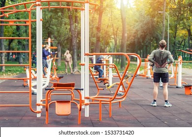 Kyiv,Ukraine - September 28th, 2019: People making sport exercises and training at public outdoor gym area at city park. Healthy lifestyle concept