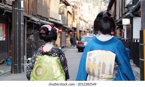 Kyoto, Japan - 4 March 2015: Geisha maiko walking on Japanese style alley while training with special powder make up