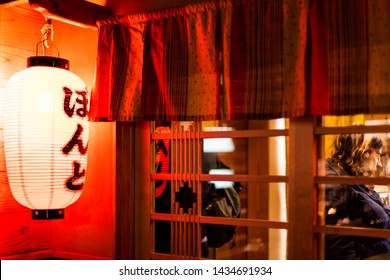 Kyoto, Japan - April 16, 2019: Pontocho Alley Sign On Red Lantern In Hiragarna In District Street At Night With Illuminated Lamp And Izakaya Restaurant Entrance Exterior