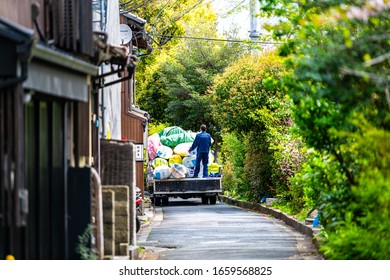 Kyoto, Japan - April 17, 2019: Neighborhood Near Takase River Canal With Green Plants And People Garbage Man On Street Cleaning Picking Up Trash