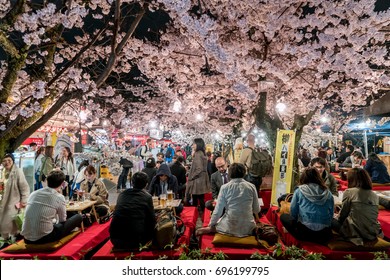 KYOTO, JAPAN - APRIL 7, 2017: Japan crowds enjoy the spring cherry blossoms in Kyoto by partaking in seasonal night Hanami festivals in Maruyama Park at Kyoto, Japan.