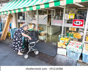 Kyoto, Japan - August 12 2013: A Senior Japanese Woman Enters A Supermarket In Kyoto. Japan Has The Most Aging Population In The World.