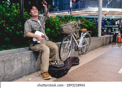 Kyoto, Japan - Circa 2015: Happy Street Musician Playing Shamisen At Kyoto Downtown Streets In The Night Next To His Bike