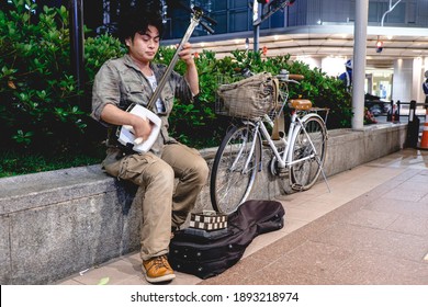 Kyoto, Japan - Circa 2015: Street Musician Playing Shamisen At Kyoto Downtown Streets In The Night Next To His Bike