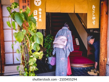 Kyoto, Japan - Circa 2016: Old Couple (woman With Kimono) Taking Off Their Shoes When Entering A Traditional House (restaurant Or Tea House)