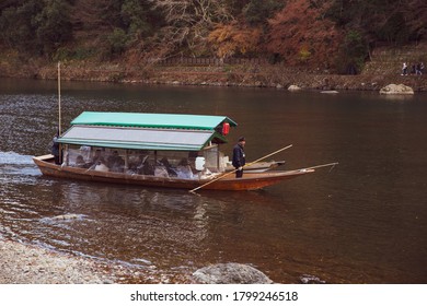 Kyoto, Japan - December 5, 2017: Tourists sightseeing boat in Katsura river at Arashiyama, in autumn - Shutterstock ID 1799246518