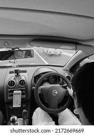 Kyoto, Japan - June 10, 2022 Man Driving Inside The Car With Sunglasses Black And White Rear View Mirror 