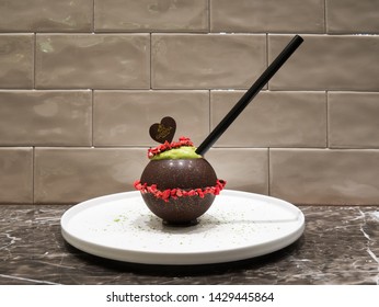 Kyoto, Japan - March 31, 2019: Seasonal strawberry smoothie in a spheric chocolate cup at Godiva boutique in Daimaru department store