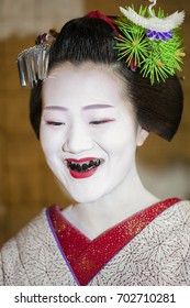 KYOTO, JAPAN - MAY 24 2016: Portrait of Maiko with black teeth, a custom known as o-haguro and was said to complement the white paint makeup and signified wealth and sexual maturity of Japanese women.