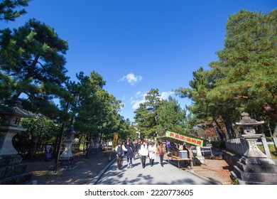 KYOTO, JAPAN - November 24, 2017: Tourists And Locals Walk Along A Street Filled With Several Food And Festival Booths In Kitano Tenmangu Shrine In Autumn.