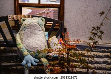 Kyoto, Japan, November 24, 2018: Frog Plush Toy And Autumn Leaves