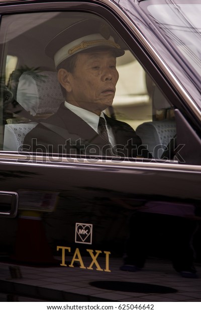 KYOTO, JAPAN - OCTOBER 8, 2016: Unidentified\
taxi driver in Kyoto, Japan. Japan has an estimated 260,000 taxis\
operating nationwide.