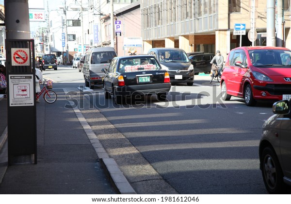 Kyoto, Japan-March 11, 2013: Taxi and people on the\
streets of Kyoto