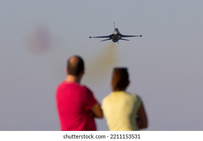 Kyrenia, Girne Northern Cyprus, TRNC  November 13th 2022  A General Dynamics F16 Fighting Falcon Fighter Plane Flies Towards Two People, Spectators Of An Airshow