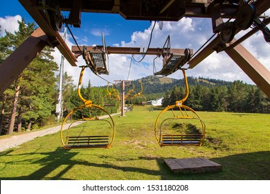 Kyrgyzstan, Karakol Ski Resort - August 22, 2019. Summer Mountain Landscape High In The Mountains. Tall Trees Of Christmas Trees, Ski Lift At The Ski Base