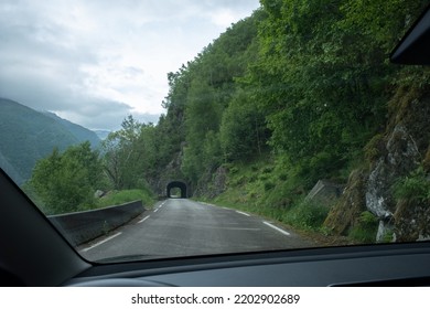 Kyrping, Norway - June 9, 2022: The Old Akra Fjord Road, POV From A Tesla Model 3 Driving On The Scenic Route. Tunnel And Bridges In A Cloudy Spring Day. Selective Focus