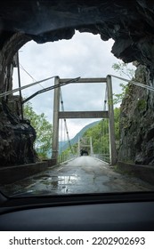 Kyrping, Norway - June 9, 2022: The Old Akra Fjord Road, POV From A Tesla Model 3 Driving On The Scenic Route. Tunnel And Bridges In A Cloudy Spring Day. Selective Focus