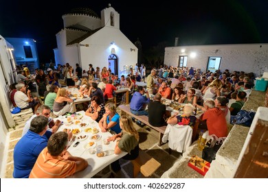 KYTHNOS, GREECE - AUGUST 14, 2014: People gathering to celebrate and feast on Assumption's eve at the church of Panagia Stratolatissa