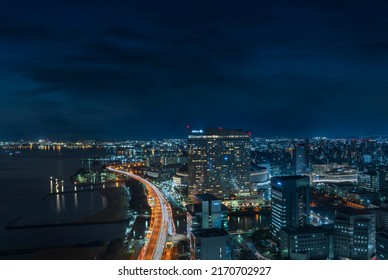 kyushu, fukuoka - december 06 2021: Bird's eye view of a night cityscape of Fukuoka coast with the illuminated urban expressway circular route from the observation deck of the Fukuoka Tower.