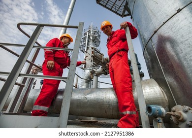 Kyzylorda Region, Kazakhstan, May 01, 2012: Two Oil Workers On Refinery Plant On Distillation Tower. 