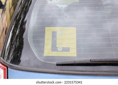 L Plate learner driver plate on back window of car